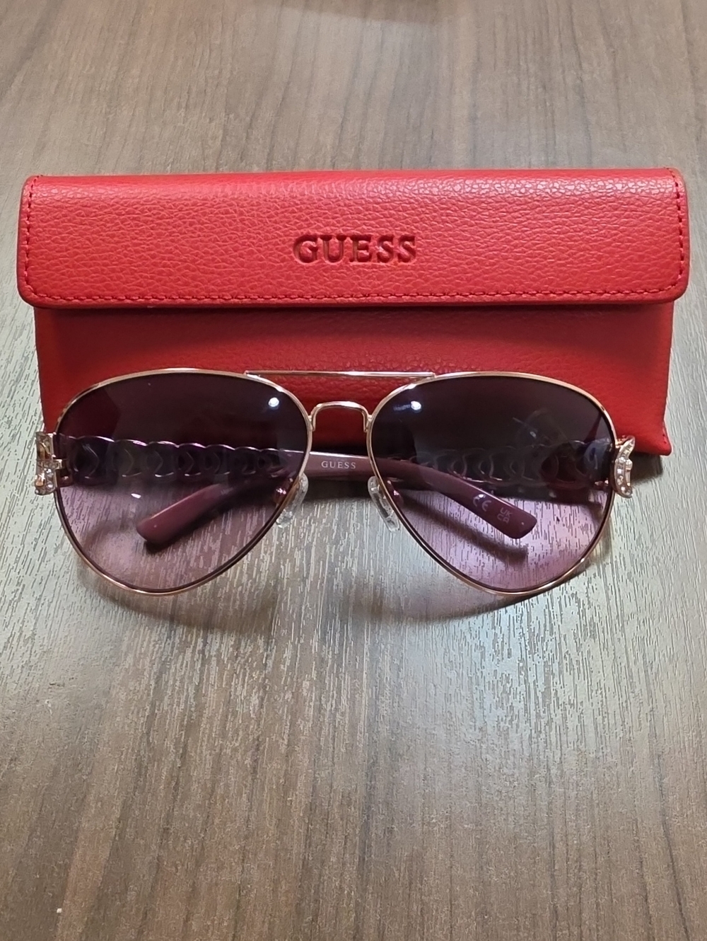 GUESS Rose-Tinted Aviator Sunglasses with Gold Frame and Red Case